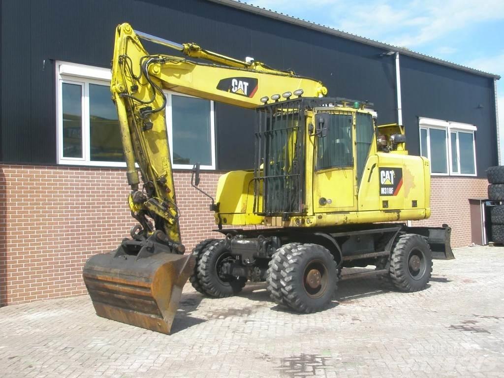 CAT M318F Bagri na kolesih